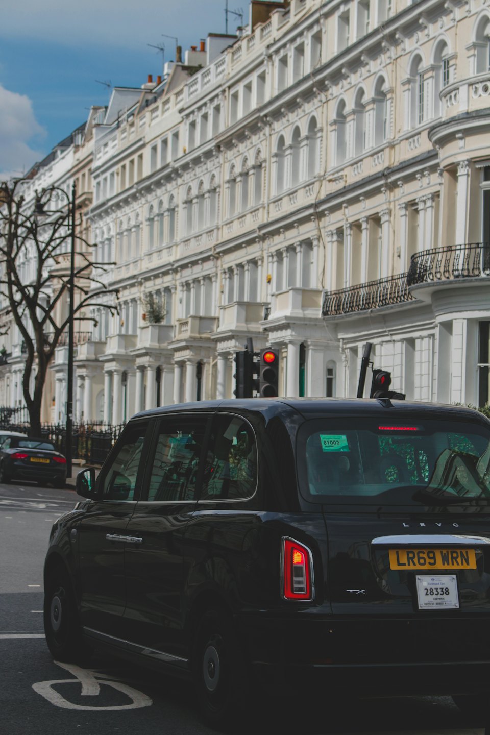 FAQ Schwarzes Taxi wartet an einer Stadt Ampel.